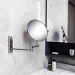 Espejo-de-baño-doble-cara-redondo-con-base-de-anclaje-a-pared-y-brazo-metalico-extensible.-Diseño-sin-bordes.